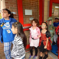 <p>Students make their way through the doors of the school to march in the parade. </p>