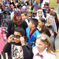 <p>Hundreds of students, faculty and parents dress in costume. </p>