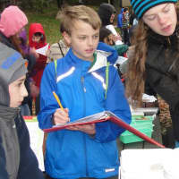 <p>Sixth-graders take notes on their observations. </p>