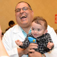 <p>Director of Neonatology at White Plains Hospital Dr. Jesus Jaile-Marti, of Hartsdale, laughs with NICU graduate Anthony Forgione, also of Hartsdale.</p>