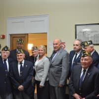<p>Mount Kisco Deputy Mayor George Griffin. fifth from right, poses for photos with local American Legion members and Mayor Michael Cindrich.</p>