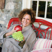 <p>North Salem resident Charmaine Lord poses with Romanesco broccoli and a pomegranate. </p>
