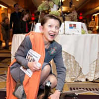 <p>Susan Beer of North Salem gets to meet one of the guests of honor at the SPCA&#x27;s Top Hat and Cocktails Gala.</p>
