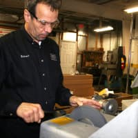 <p>Robert Ambrosi sharpens a knife at North Salem&#x27;s Ambrosi Cutlery. </p>