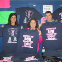 <p>Joanne Bartolomeo, Joan Messinger and Tom Baker hold up Hen Hud cheerleading shirts.</p>