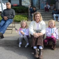 <p>Kerry Chillo and her daughters patiently wait for the parade to begin in downtown Stamford.</p>
