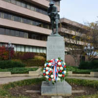 <p>Flowers are placed in Veterans Park during the ceremony in honor of Veterans Day, which is officially on Tuesday, Nov. 11. </p>