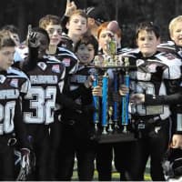 <p>Fairfield Giants Pee Wee players celebrate with the trophy afte the win.</p>