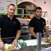 <p>Tijuana Mexican Grill co-owner Walter Escobar with Osvin Mejia serving lunch.</p>