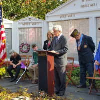 <p>Probate Judge Dan Caruso speaks to a crowd of about 50 standing in front of the Wall of Honor on Old Post Road.</p>