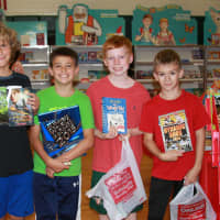 <p>Holmes School fifth-graders Wyatt Marcous, James Tomasello, Jack Walsh and Lance Anavy from Micaela Tucker&#x27;s class visit the book fair.</p>