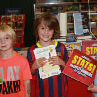 <p>Holmes School first-graders Griffin Ruppenstein, Jay Franzese and Shawn Rideout from Kimberly Paladino&#x27;s class explore the sports section at the book fair.</p>