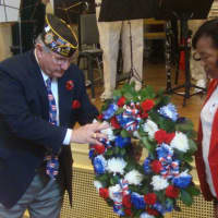 <p>Members of the VFW and American Legion place a ceremonial wreath in front of the stage at Westport Town Hall.</p>