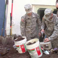 <p>Cadets from West Point work on one of the high street homes</p>