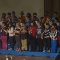 <p>Fourth grade students at Naramake Elementary School in Norwalk perform a musical tribute to members of the armed services during the school&#x27;s Veterans Day assembly.</p>