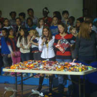 <p>Naramake Principal Patti Mattera and members of the PTO unveil how much candy the students donated for the troops during the candy drive.</p>
