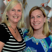 <p>Jackie Hvolbeck and Stephanie Ashley at the Oktoberfest Giving Tree.&quot;</p>