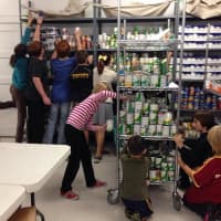 <p>Volunteers help stock the Sleepy Hollow/Tarrytown Food Pantry.</p>