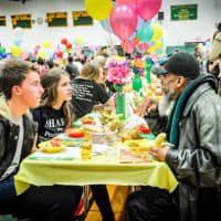 <p>Volunteers and guests chat at Project SHARE&#x27;s annual Thanksgiving dinner.</p>