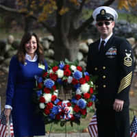 <p>Weston First Selectman Gayle Weinstein and Andrew Cumming present a wreath during Veterans Day ceremonies at Weston Middle School.</p>
