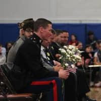 <p>Veterans listen to speeches at a ceremony Tuesday at Weston Middle School.</p>