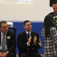 <p>Westpn police officer Chris Powers receives flowers from a Weston Middle School student.</p>