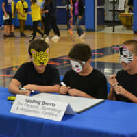 <p>The boys of &quot;Spelling Beasts&quot; compete while wearing masks. </p>