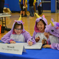 <p>Members of &quot;TB(ee)D&quot; compete in unicorn costumes.</p>