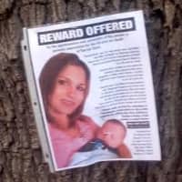 <p>&quot;Reward Offered&quot; signs are posted on trees, buildings and other locations near the scene of the fatal accident. </p>