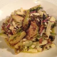 <p>Warm brussels sprout salad with bacon, apples and bleu cheese is available for Thanksgiving takeout at 12 Grapes in Peekskill.</p>