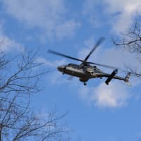 <p>A helicopter flies overhead during the response to a fatal car collision in Southeast.</p>