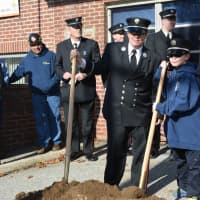 <p>Patricia Gallagher, a lieutenant with the Croton Falls Fire Department, holds a shovel alongside her son, Timothy.</p>