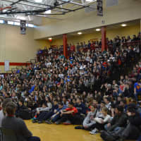 <p>Members of Somers High School&#x27;s varsity girls soccer team sit in a row facing a packed crowd at an assembly in their honor for having won a state title.</p>