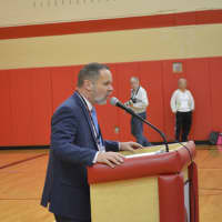<p>Somers High School Principal Mark Bayer addresses an assembly in honor of the varsity girls soccer team&#x27;s state title victory.</p>