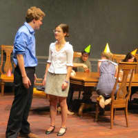 <p>John Jay High School sophomore Barrett Middleton and senior Isabel Maher stand in the foreground of a scene in The Dining Room by A.R. Gurney.</p>