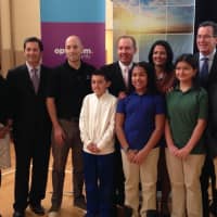 <p>Gov. Dannel Malloy and Mark Elliott of The Weather Channel pose with students Wednesday at Inter-district Discovery Magnet School in Bridgeport. </p>