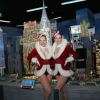 <p>The Rockettes pose by the brick model.</p>
