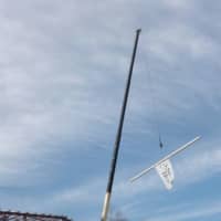 <p>The ceremonial beam - with Convent of the Sacred Heart flag attached to it - is raised during the &quot;topping Off&quot; ceremony Thursday for the school&#x27;s new athletic center. </p>