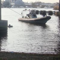 <p>The SUV is pulled out of the water by a tow truck from Nat&#x27;s Garage.</p>