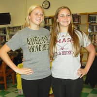 <p>Power and Haplin pose with their shirts that represent the colleges they will attend.</p>