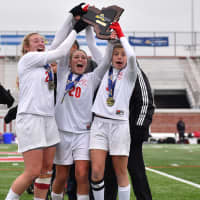 <p>Somers players hoist the state-championship trophy moments after taking the title.</p>