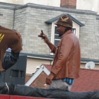 <p>A coolest guys in the parade on top of one of the floats enjoy the parade.</p>