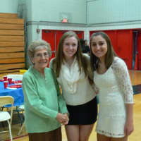 <p>Two Eastchester High School volunteers with a senior. </p>