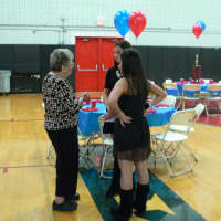 <p>Eastchester High School volunteers discuss among each other. </p>