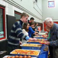 <p>Eastchester High School volunteers serve finger foods to the seniors. </p>