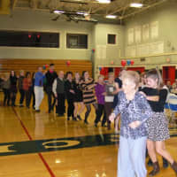 <p>Participants and volunteers dance in a conga line. </p>