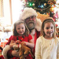 <p>LMMM Trustee and Stew Leonards Vice President Doug Hempstead, with two Santa fans in 2013.</p>