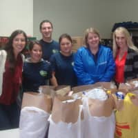 <p>Tauck employees Julia O&#x27;Brien, Kristen Kaczegowicz, Aaron Wasserman, Emily Yip, Jennifer Catalano and Sharon Bell pack up Thanksgiving meals at Person-To-Person in Norwalk.</p>