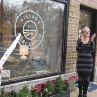 <p>Vonnie Sullivan, right, reacts to the official grand opening of Village Mercantile on Tuesday.</p>