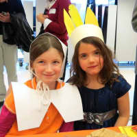 <p>Increase Miller Elementary School first-graders Megan, left, and Cordelia wore Pilgrim and Native American attire to the feast.</p>
